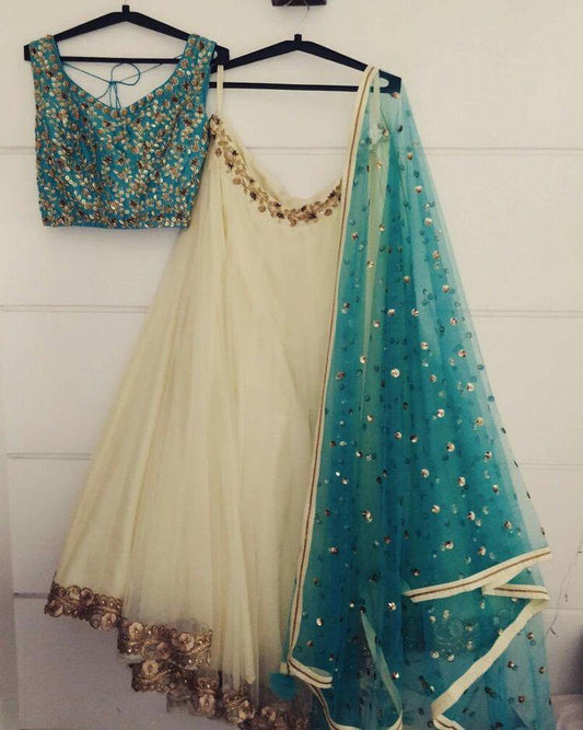 Beautiful cream soft net embroidered ceremonial lehenga choli