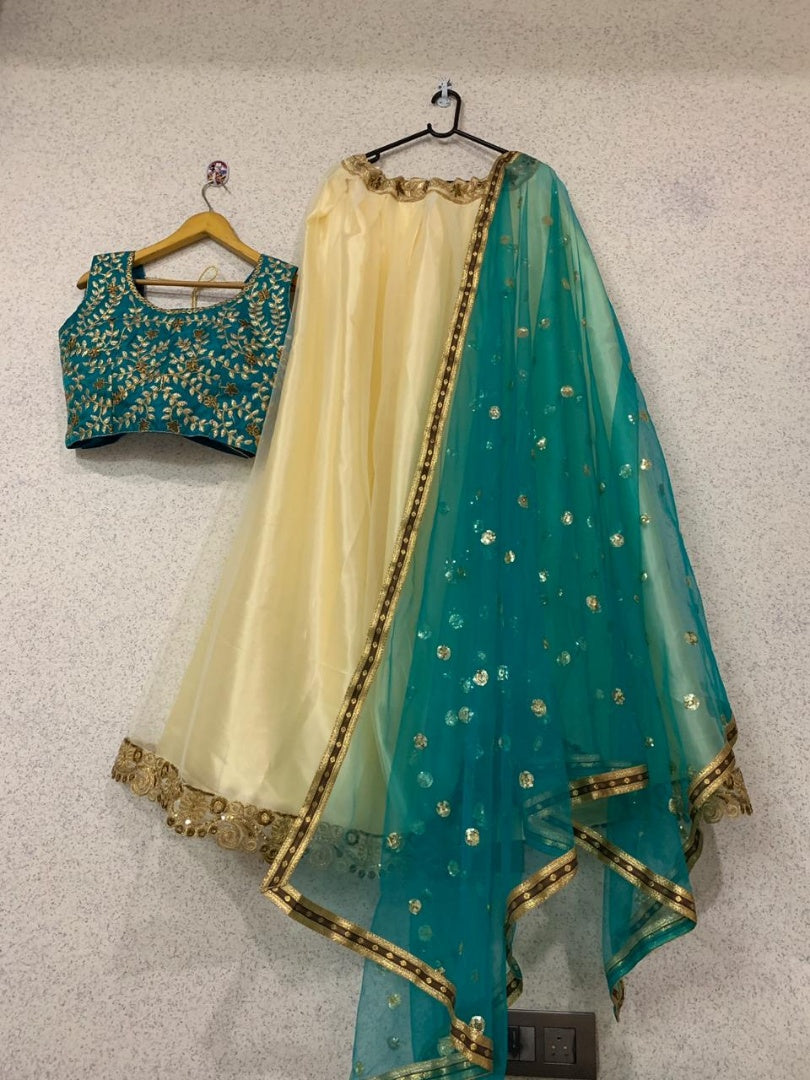 Beautiful cream soft net embroidered ceremonial lehenga choli