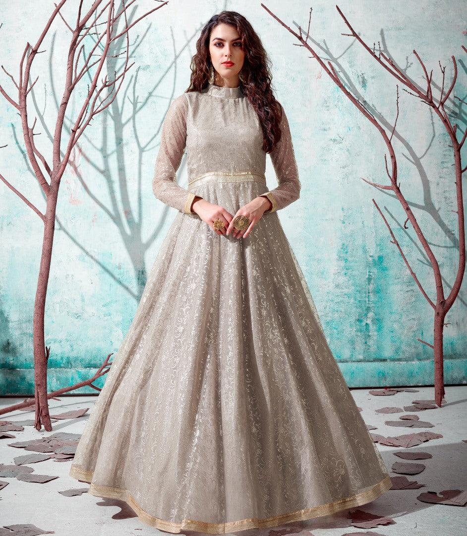 Beige net metallic foil work party wear designer gown