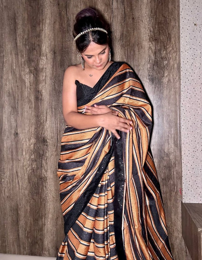 Black and orange print and sequence work party wear saree