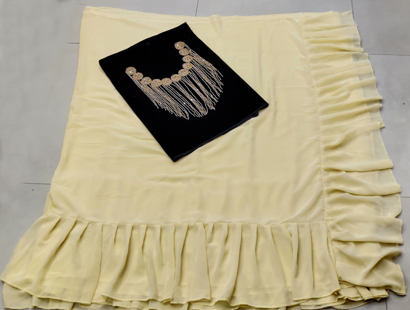 Cream georgette designer ruffle saree with handwork blouse