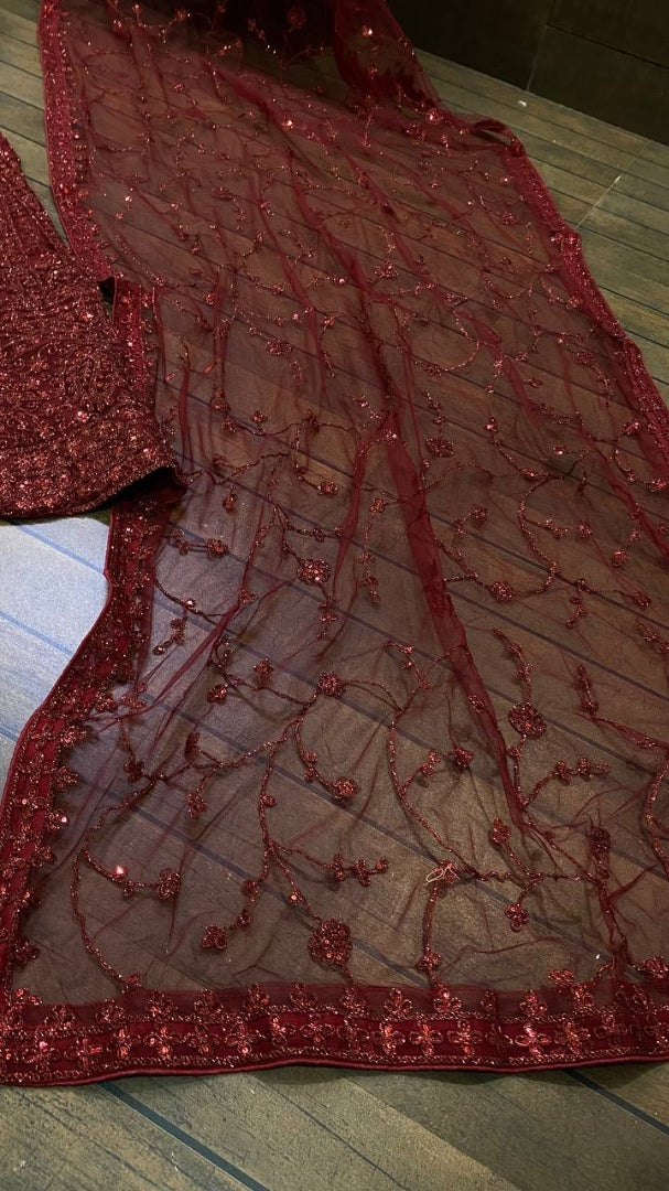 Maroon net heavy sequence and dori work embroidered bridal lehenga choli
