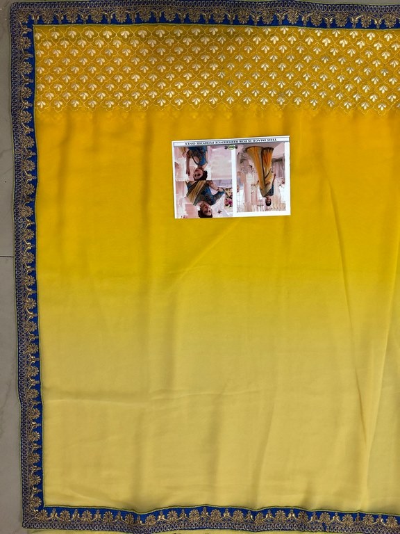 Yellow georgette embroidered wedding saree with heavy blouse