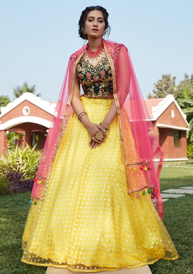 Yellow net metallic foil printed work party wear lehenga choli