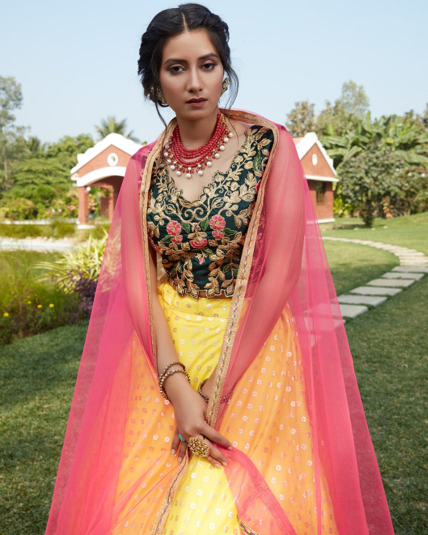 Yellow net metallic foil printed work party wear lehenga choli