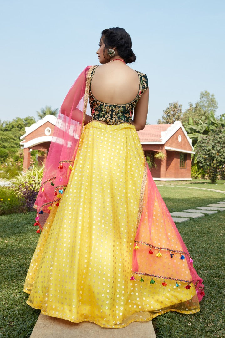 Yellow net metallic foil printed work party wear lehenga choli