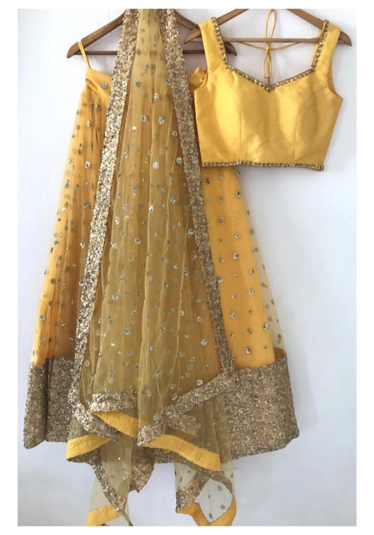 Yellow net sequence work ceremonial lehenga choli