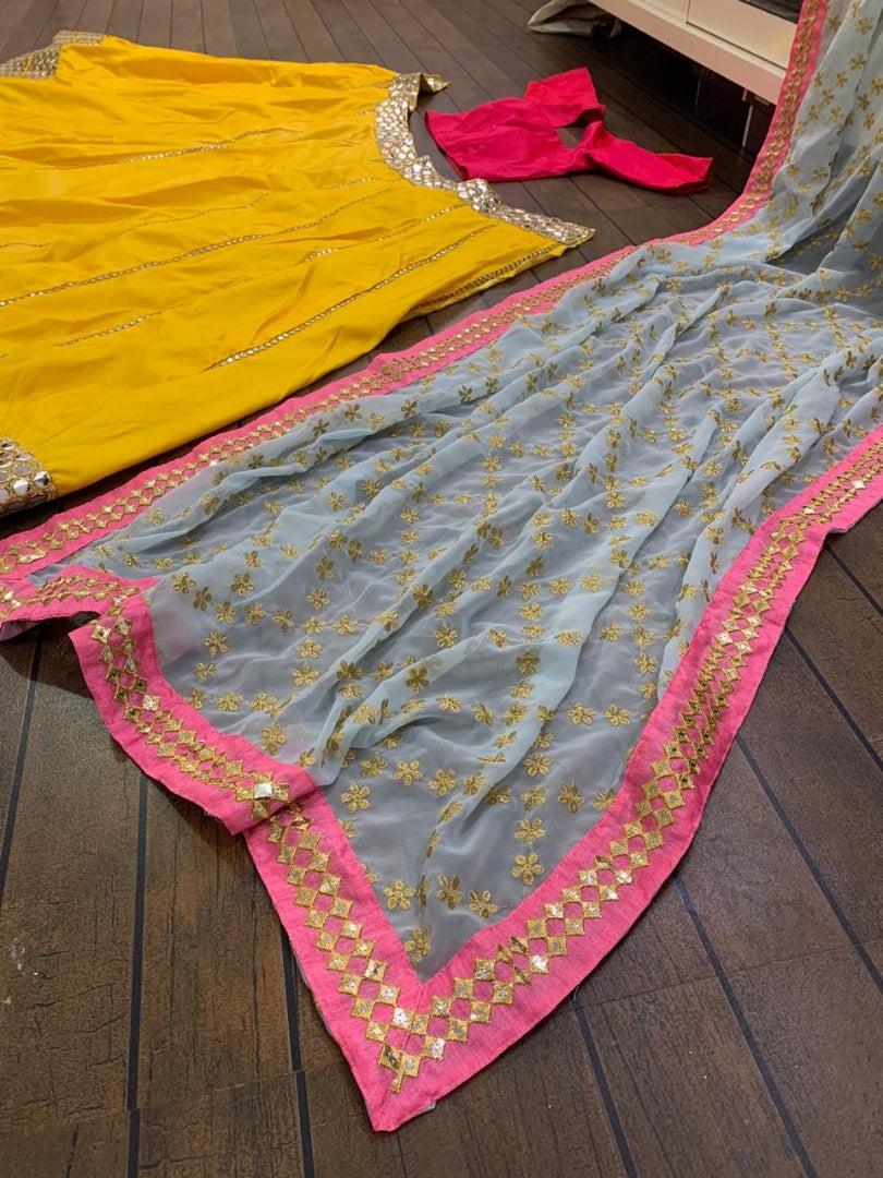 Yellow tapeta silk foil mirror work lehenga choli for ceremony