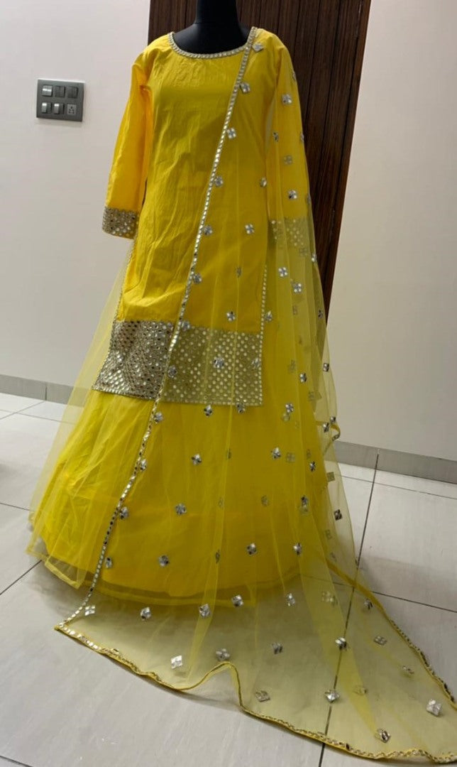 Yellow tapeta silk with foil mirror work suit lehenga