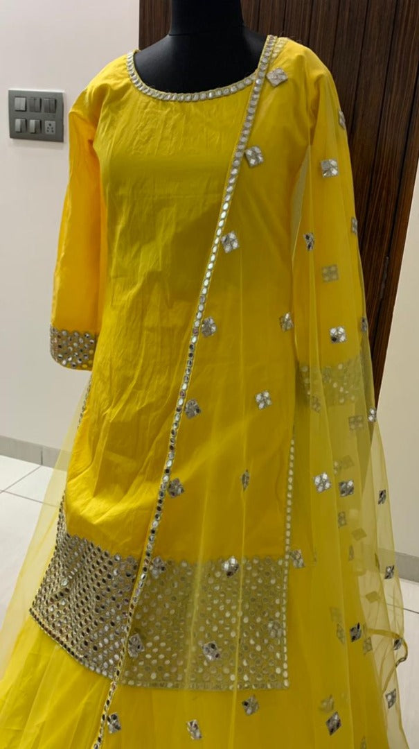Yellow tapeta silk with foil mirror work suit lehenga