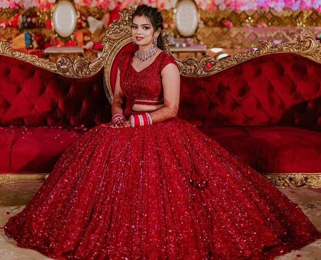 Red heavy embroidered sequence worked wedding lehenga choli