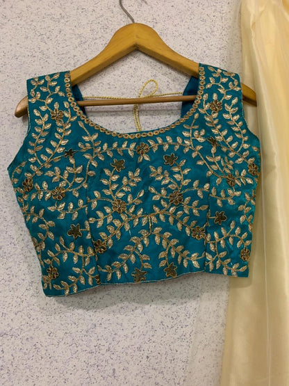 Beautiful cream soft net embroidered ceremonial lehenga choli