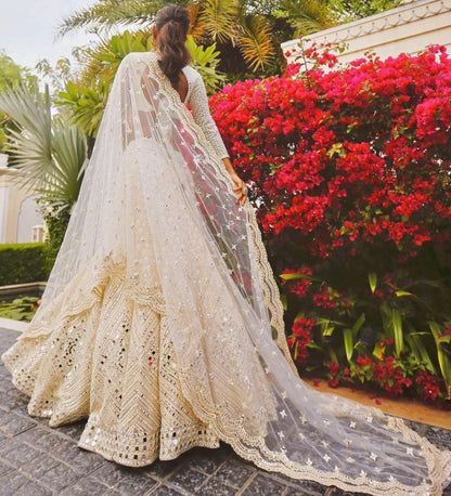 Beige soft heavy net paper mirror and thread work bridal lehenga choli