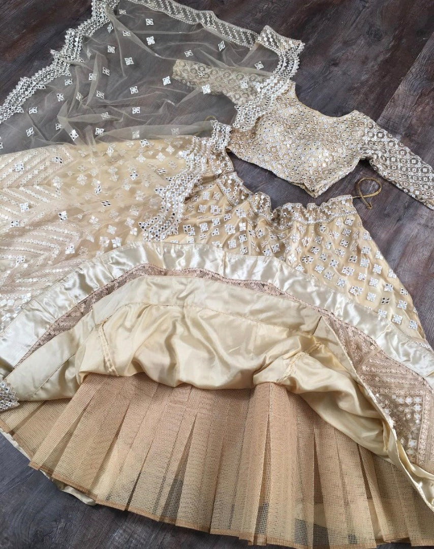 Beige soft heavy net paper mirror and thread work bridal lehenga choli