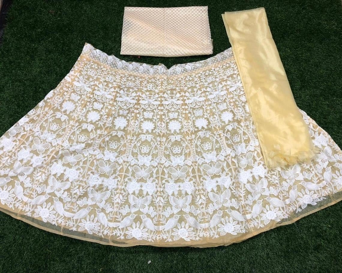 Brown net white heavy embroidered wedding lehenga