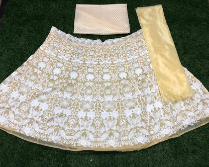 Brown net white heavy embroidered wedding lehenga