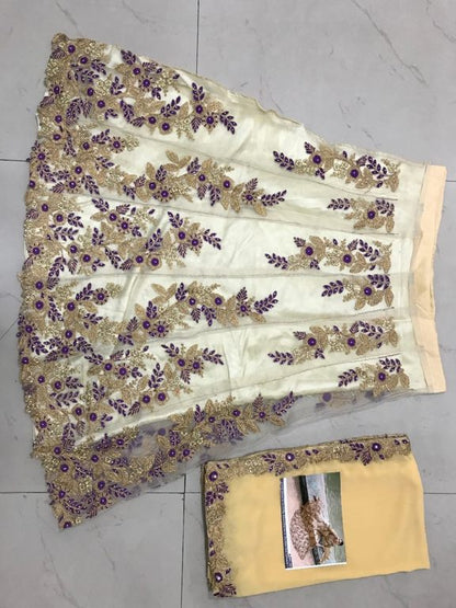 cream embroidered mono net wedding lehenga