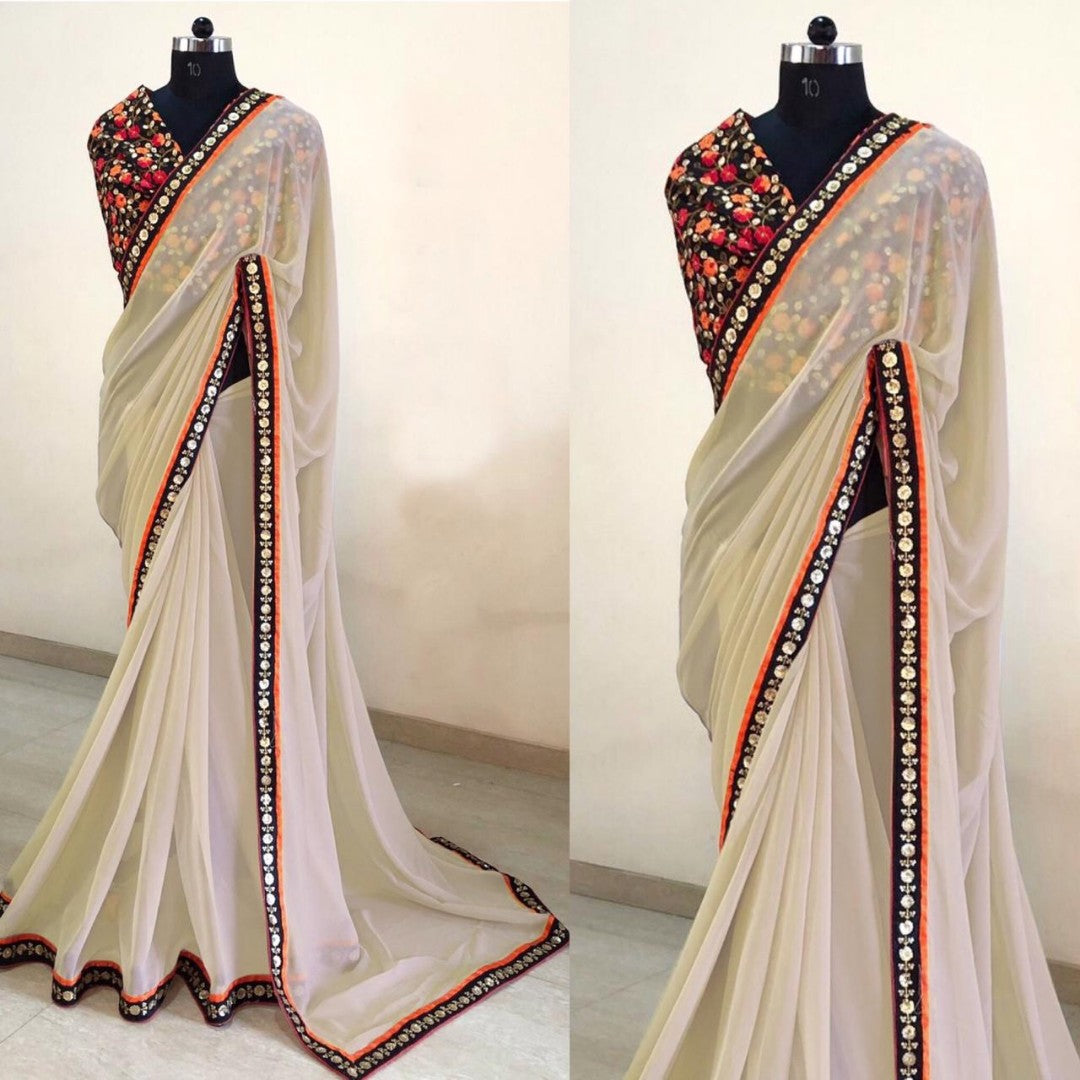 Cream georgette saree with heavy embroidered blouse