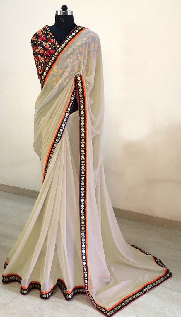 Cream georgette saree with heavy embroidered blouse