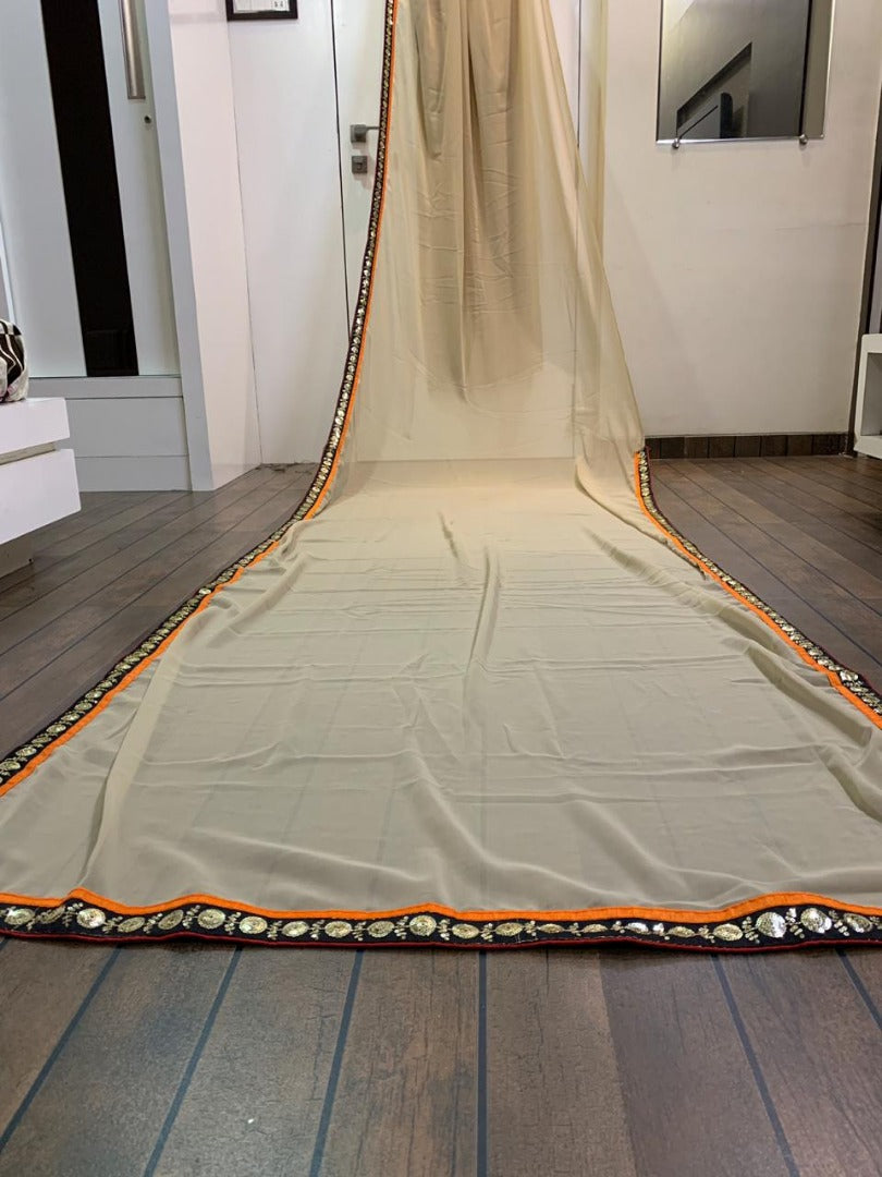 Cream georgette saree with heavy embroidered blouse