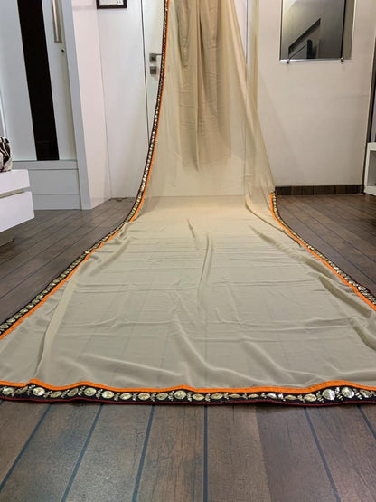 Cream georgette saree with heavy embroidered blouse