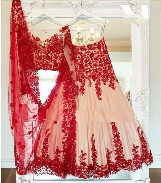 Cream net red threadwork embroidered ceremonial lehenga choli