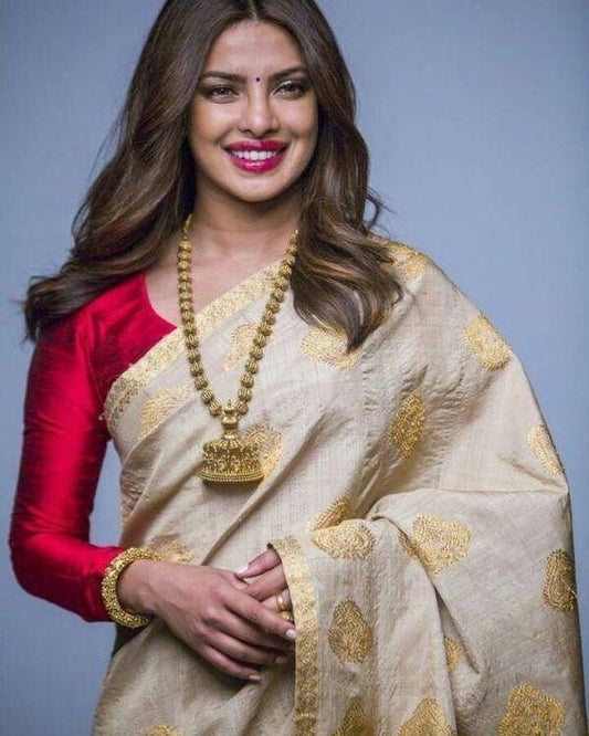 Cream zarna silk saree with red tassels