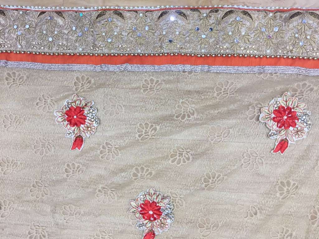 Designer embroidered orange wedding saree