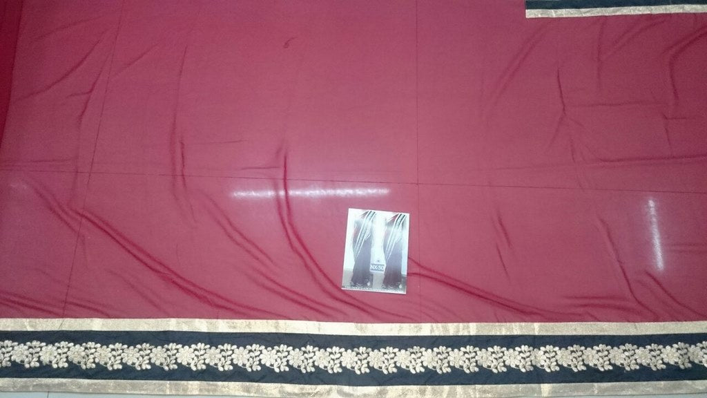 Gorgeous red saree with black embroidered lace