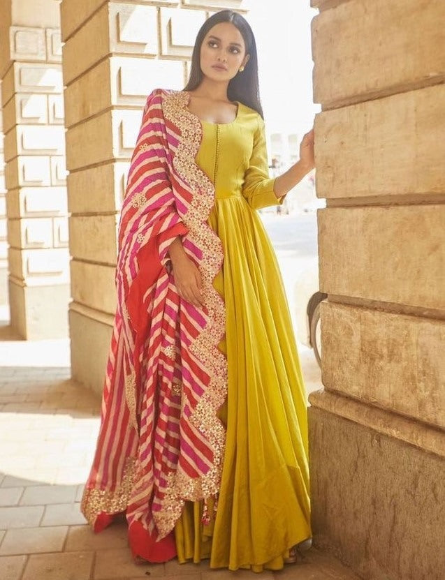 Greenish yellow silk umbrella flair plain gown with printed dupatta