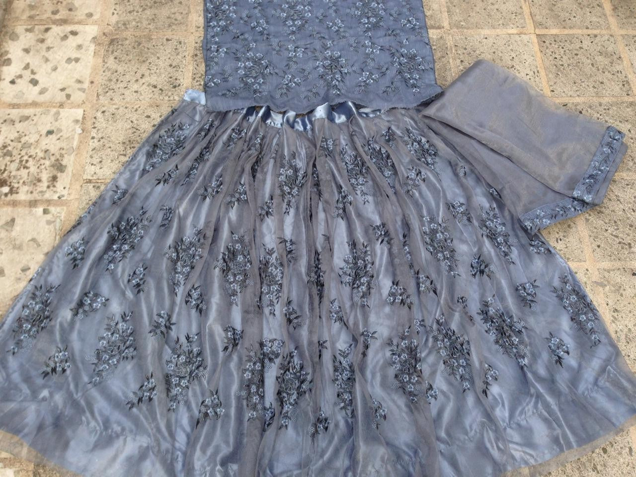 Grey net heavy embroidered wedding lehenga