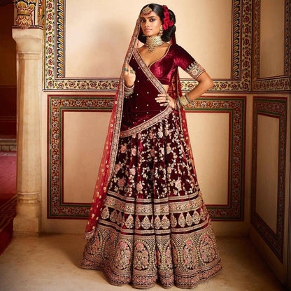 Maroon heavy velvet designer embroidered bridal lehenga with can can net