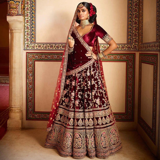 Maroon heavy velvet designer embroidered bridal lehenga with can can net