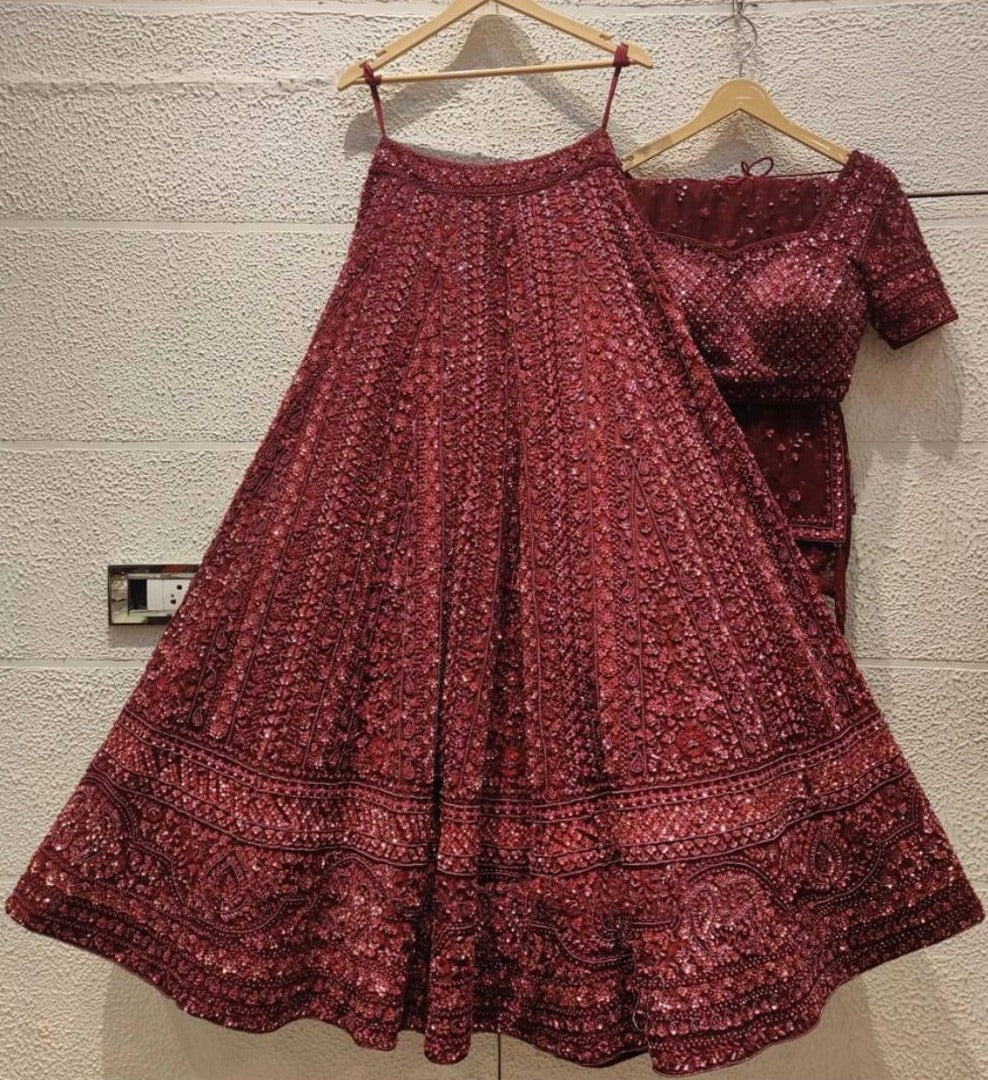 Maroon net heavy sequence and dori work embroidered bridal lehenga choli