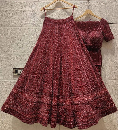 Maroon net heavy sequence and dori work embroidered bridal lehenga choli