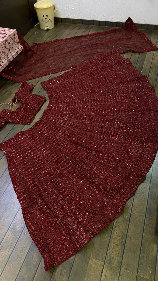 Maroon net heavy sequence and dori work embroidered bridal lehenga choli