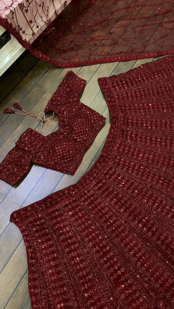Maroon net heavy sequence and dori work embroidered bridal lehenga choli