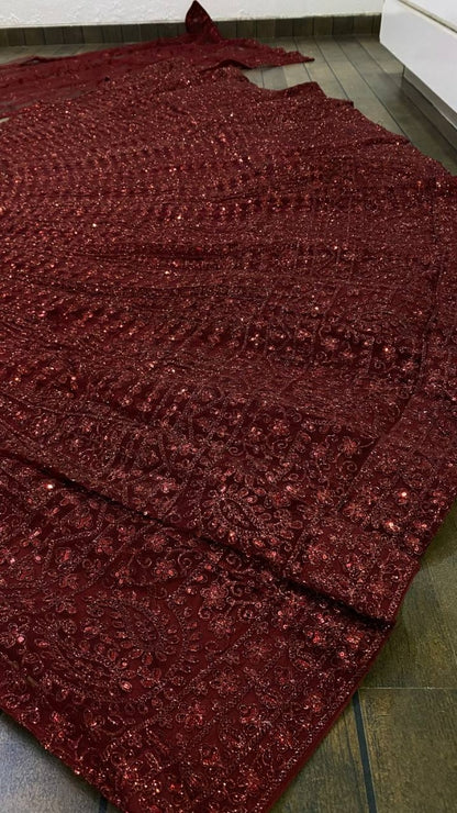 Maroon net heavy sequence and dori work embroidered bridal lehenga choli