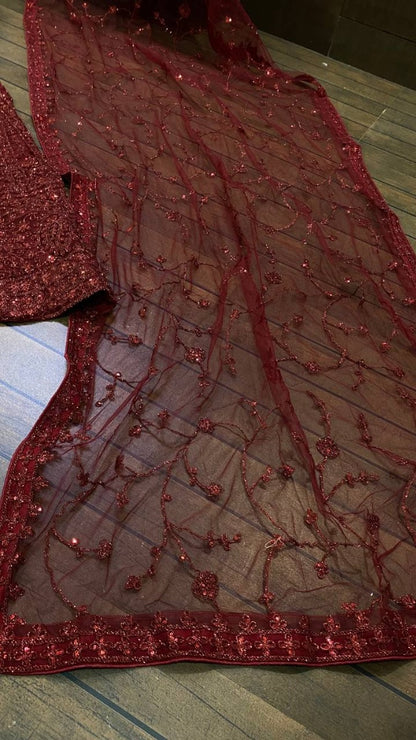 Maroon net heavy sequence and dori work embroidered bridal lehenga choli