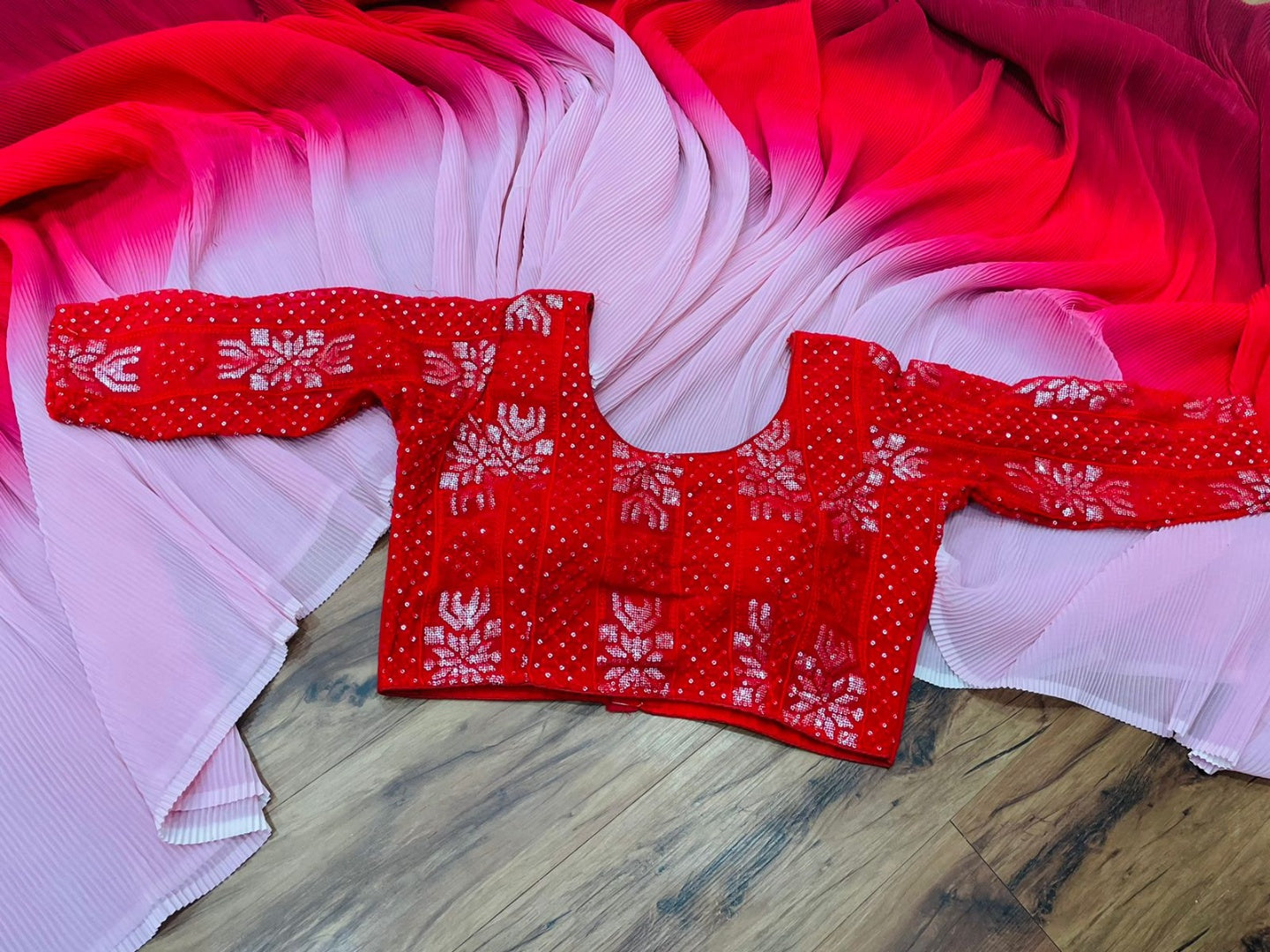Multi shade red georgette pleated saree with heavy blouse