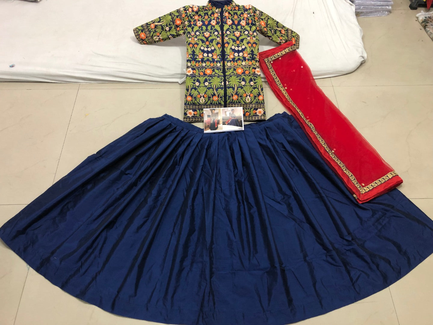 navy blue tapeta silk lehenga with heavy embroidered long choli