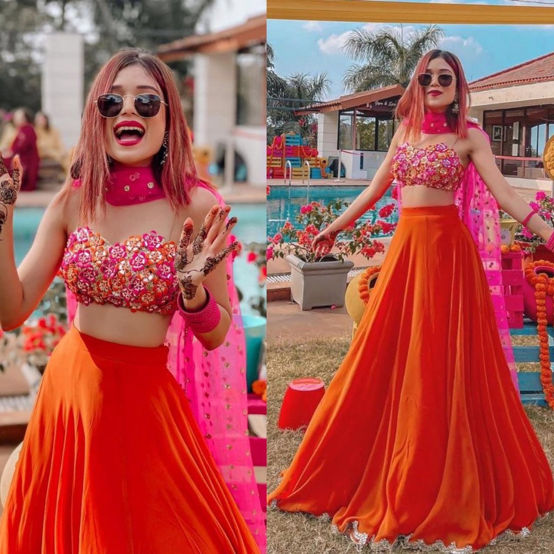 Orange ceremonial lehenga choli with heavy work blouse