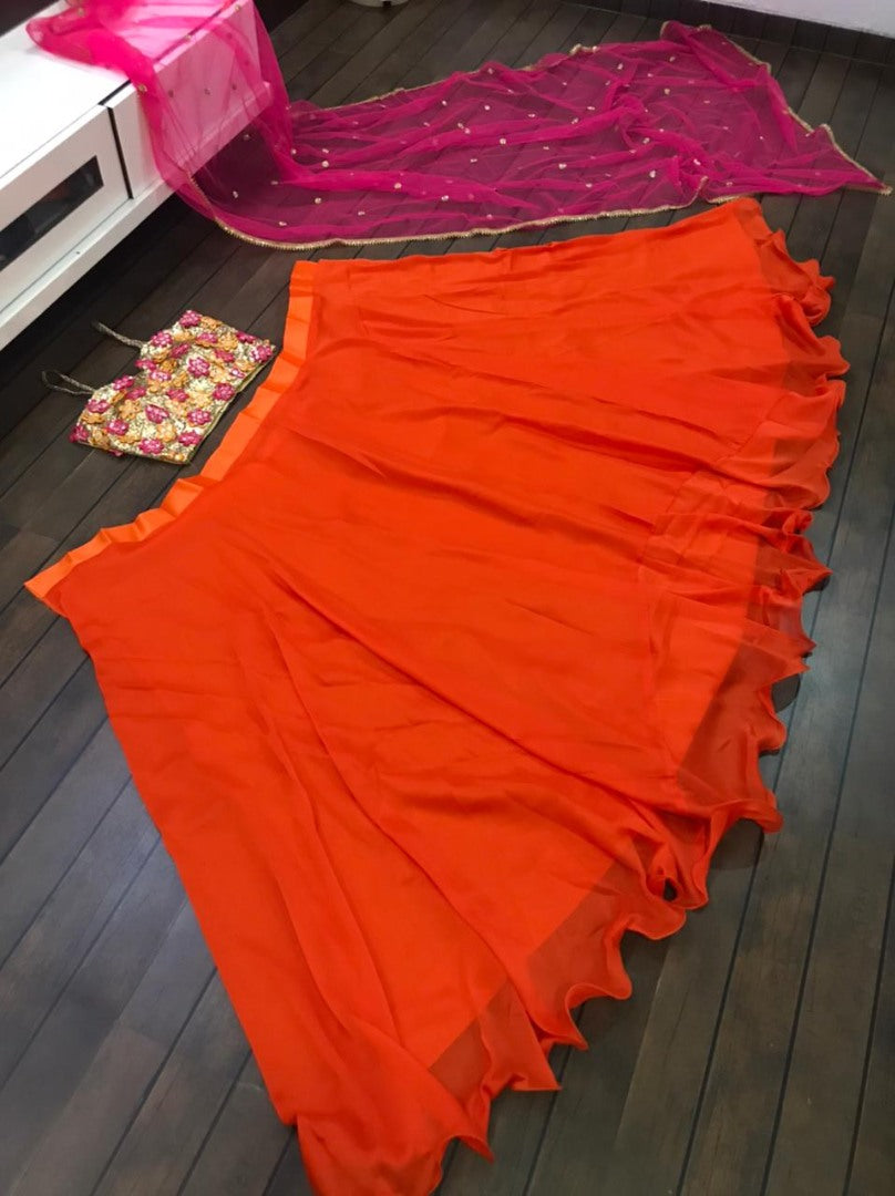Orange ceremonial lehenga choli with heavy work blouse