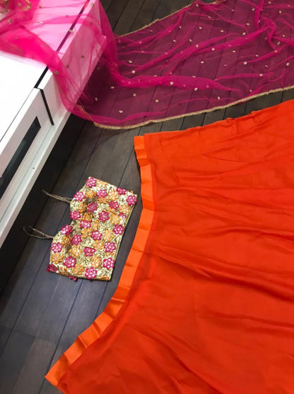 Orange ceremonial lehenga choli with heavy work blouse