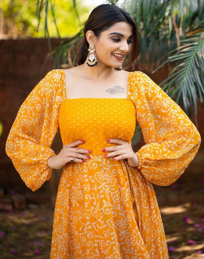 Orange georgette print and embroidery work gown