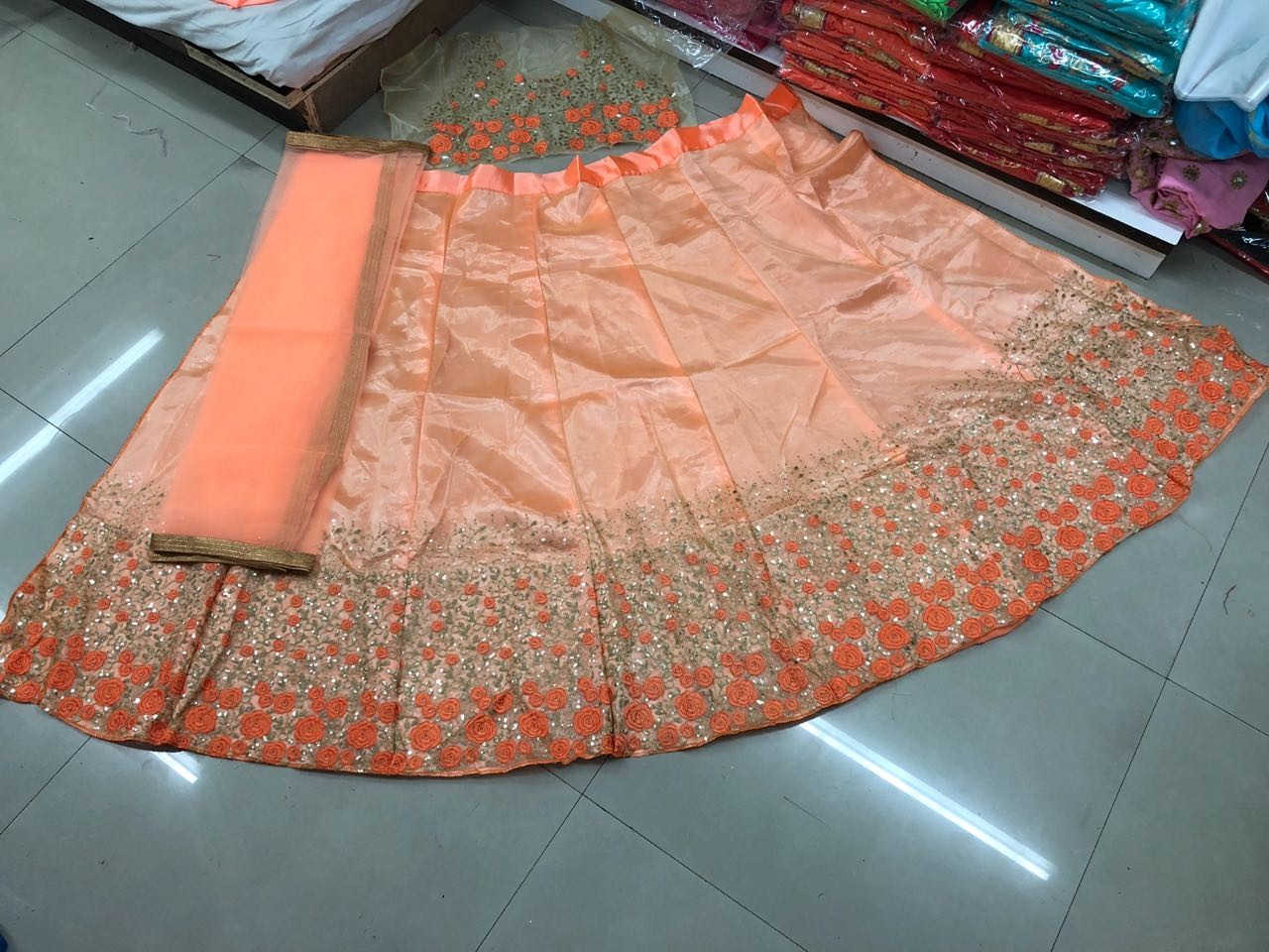 Orange net embroidered sequence wedding lehenga