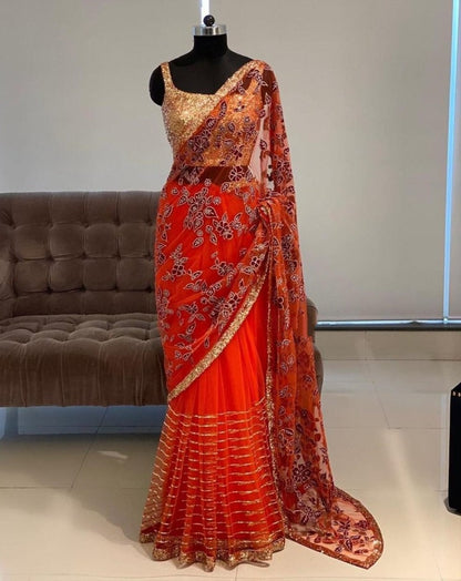 Orange net thread embroidered saree