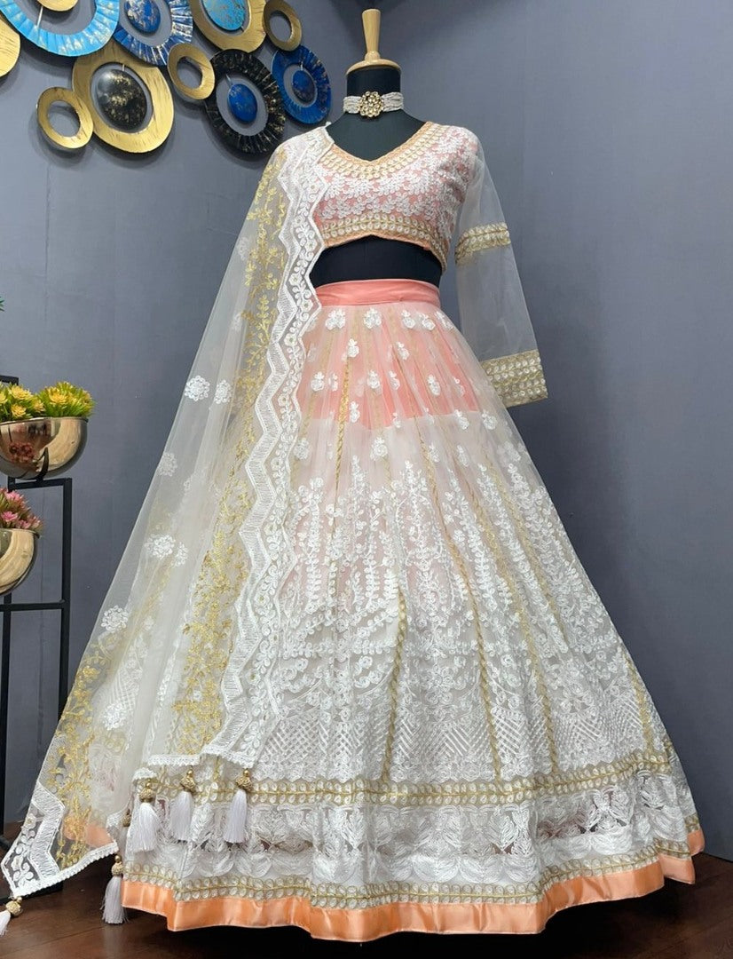 Peach and white soft net heavy embroidered lehenga choli