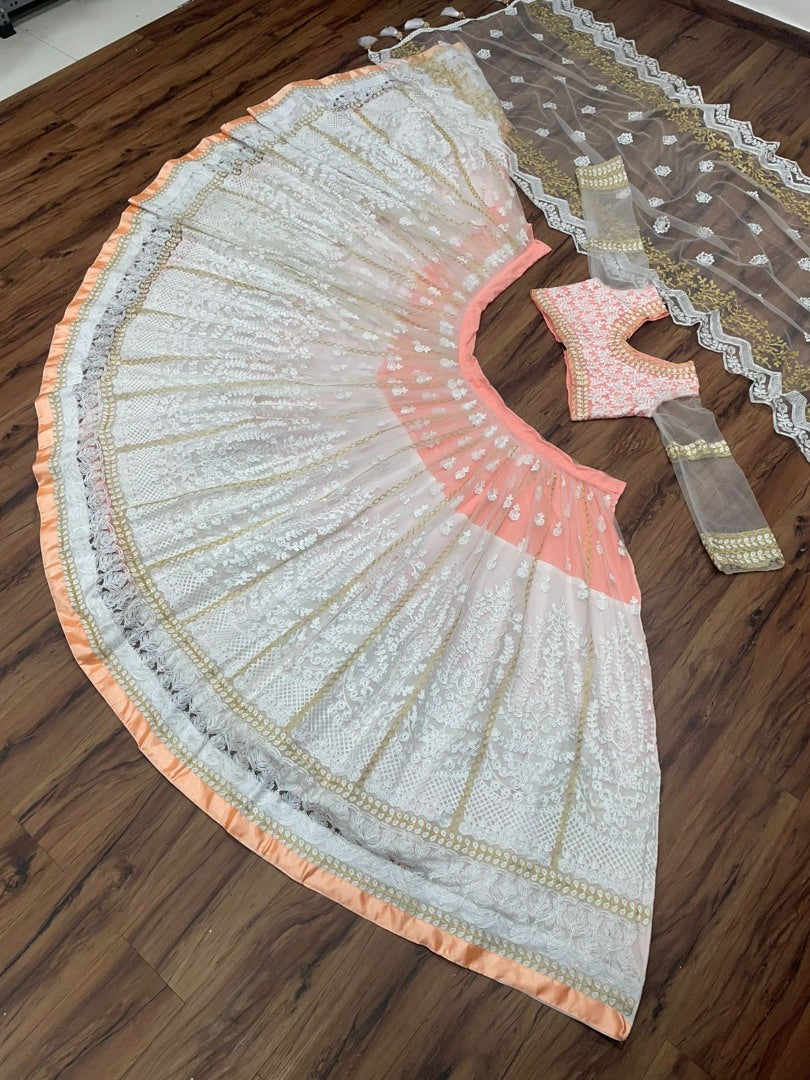 Peach and white soft net heavy embroidered lehenga choli