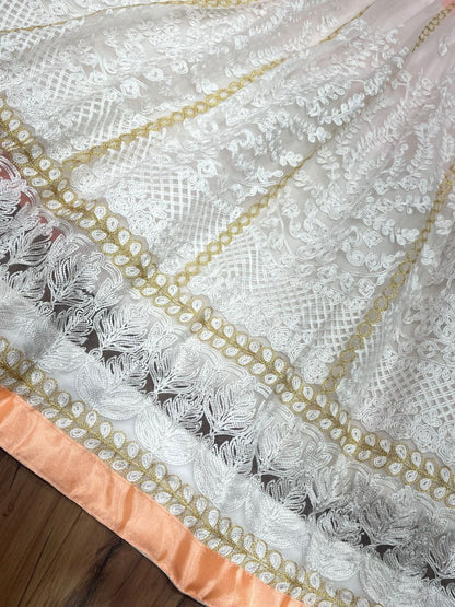 Peach and white soft net heavy embroidered lehenga choli